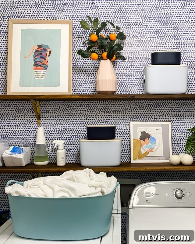 Curated Canvas Designer Artistry for Laundry Rooms 4 Styled open shelving in a laundry room, showcasing small art prints and decorative elements.