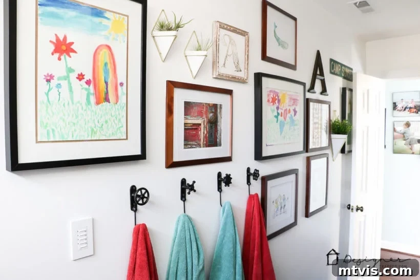 Designer-Curated Bathroom Artistry 3 Stunning DIY bathroom remodel featuring subway tile, black slate floor, penny tile accents, and a floating vanity, complemented by carefully chosen art.