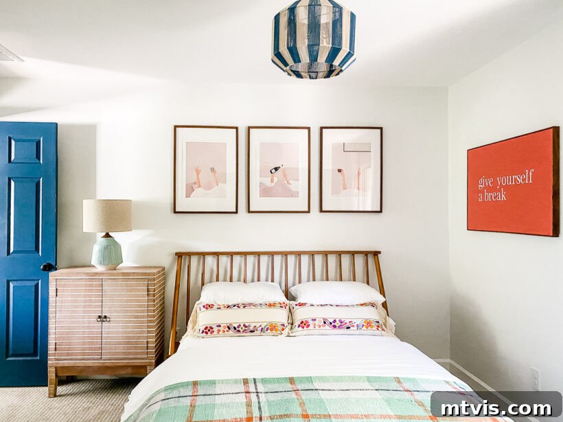 A colorful and inviting guest room featuring a unique trio of wall art prints and a custom DIY sign.