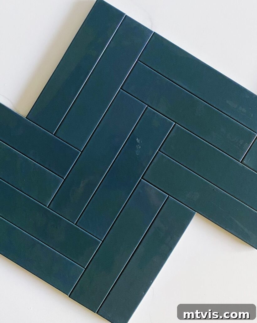 Our Fireplace Glow-Up Revealed 5 Close-up of matte Pacific Blue ceramic tile in a herringbone pattern, showing its true teal color