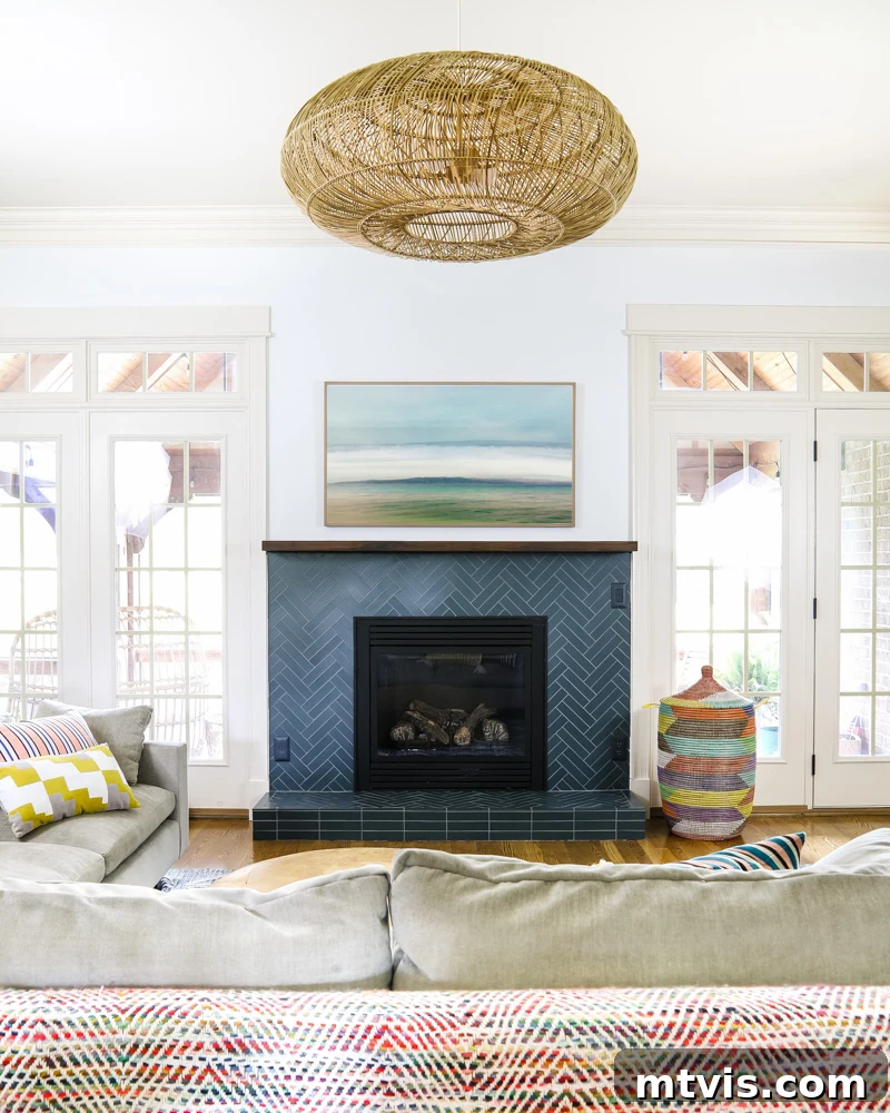Our Fireplace Glow-Up Revealed 8 Family room with a newly installed navy blue tile fireplace, showing integrated outlets