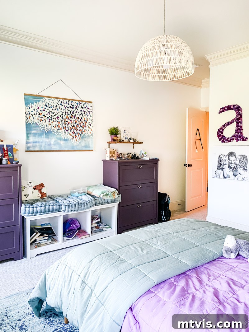 Before shot of a girl's bedroom with purple and blue accents, showcasing a temporary and unorganized setup.
