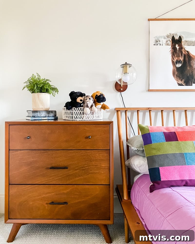A contemporary 3-drawer dresser in Avery's mid-century modern bedroom, offering practical storage without compromising on style, strategically placed near her closet.