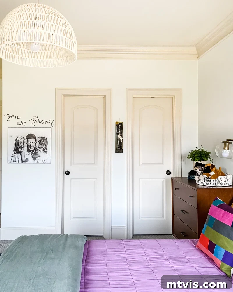 Detail shot of the desk area in the mid-century modern bedroom, showcasing organizational bins and a creative workspace.
