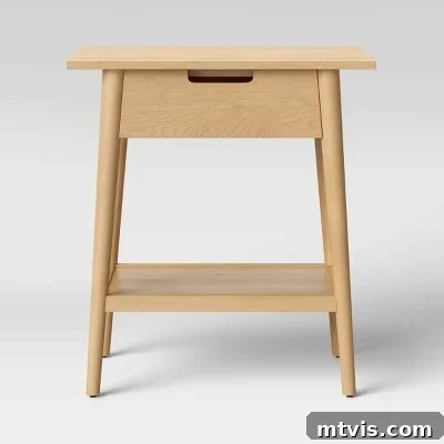 A simple yet stylish light brown wooden nightstand with a single drawer for easy storage, perfect for modern bedrooms.