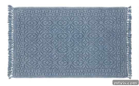 Splash of Style: Top Bath Mats for Bright Bathrooms 5 This blue textured geometric bath mat stands out as one of the best bath mats for color lovers, offering a blend of traditional style and vibrant color to enhance any bathroom decor.