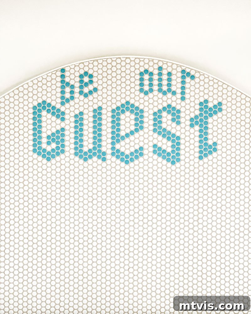 Finished DIY headboard with custom message 'BE OUR GUEST'