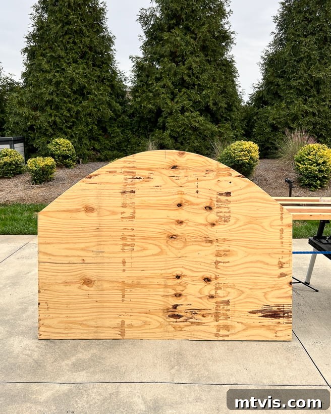 Arched headboard shape cut out of plywood