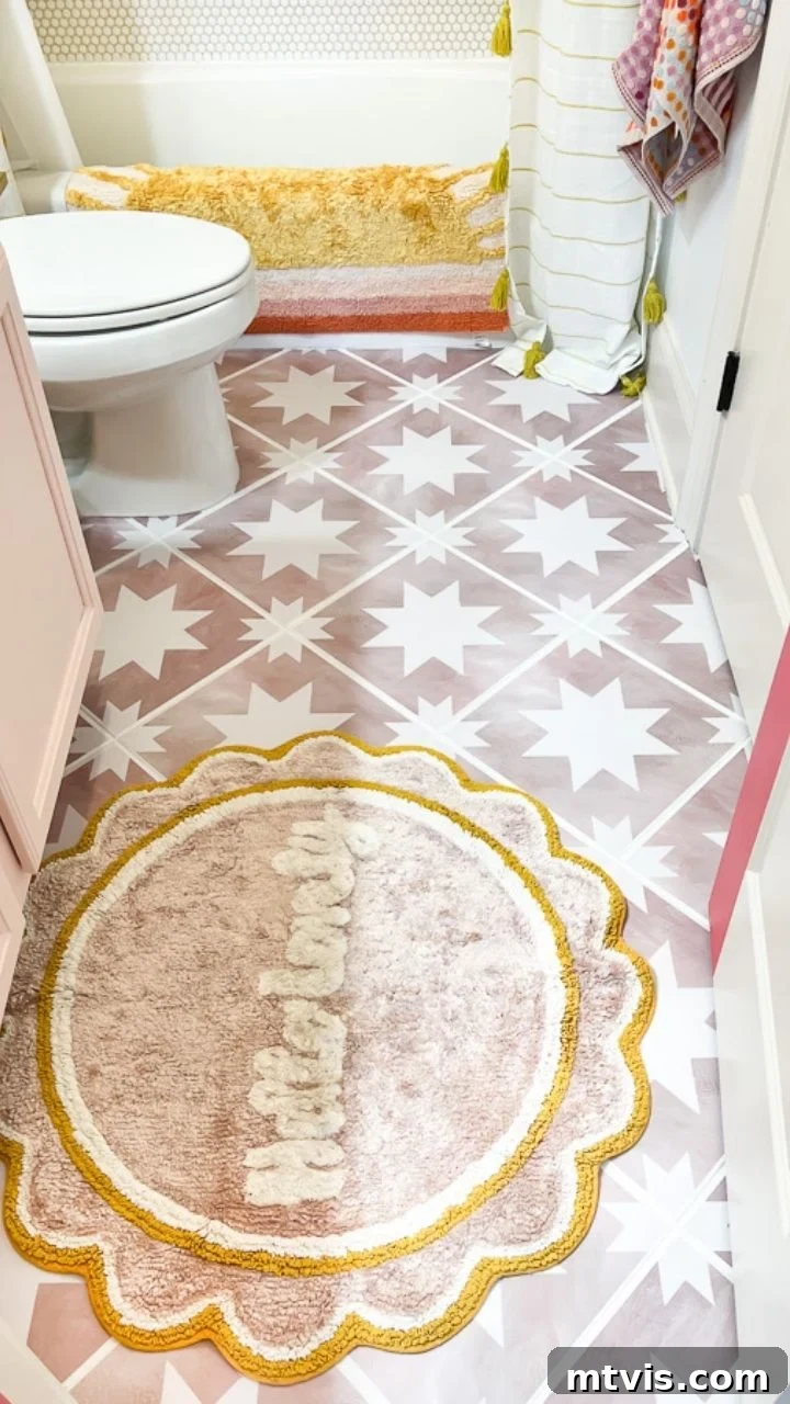 Pink star tile stickers on a bathroom floor, beautifully updated and maintained, demonstrating the successful application of peel and stick tiles in a modern home by Tasha Agruso of Kaleidoscope Living.