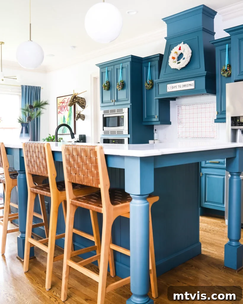 A Spectrum of Holiday Cheer: Our 2021 Christmas Home Tour 5 A charming blue kitchen elegantly decorated for the Christmas holidays, showcasing a cozy and inviting atmosphere.