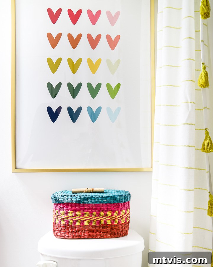 No bathroom makeover on a budget is complete without colorful artwork like rainbow heart artwork and a rainbow toilet paper basket. 