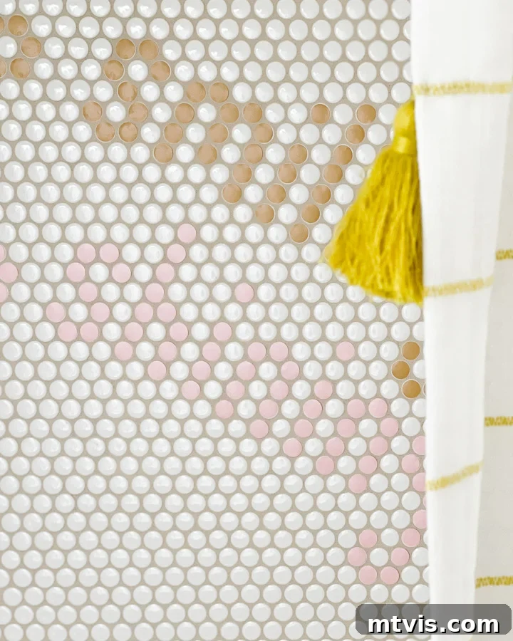 White penny tile in shower has been customized to add the word "smiling" in two different colors.