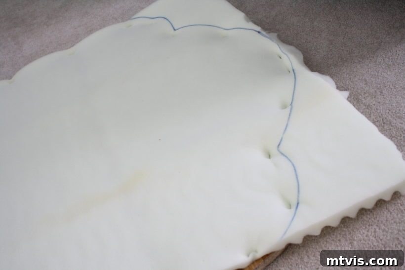 Build Your Upholstered Headboard in an Afternoon 7 Applying and stapling the double-layered egg crate mattress topper to the wooden headboard base for plush padding.