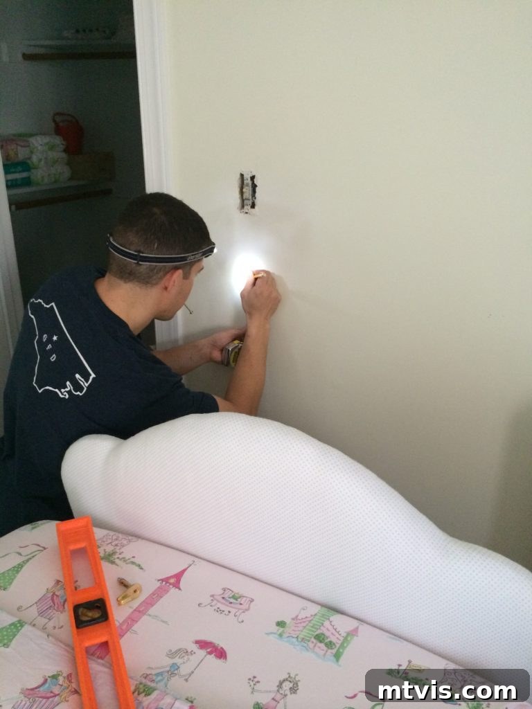 Build Your Upholstered Headboard in an Afternoon 12 The newly upholstered headboard being hung on the wall using D-rings, ready to complete the bedroom look.