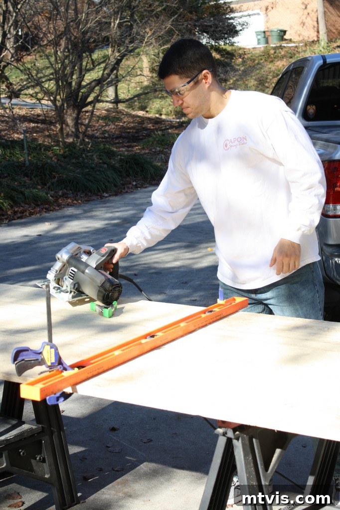Build Your Upholstered Headboard in an Afternoon 4 Careful measurements being taken on the wood panel before making the final cuts for the upholstered headboard.