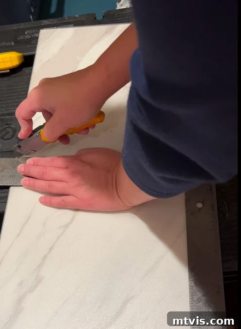 Install a Floating Tile Floor Like a Pro 6 A utility knife being used to cut a floating tile
