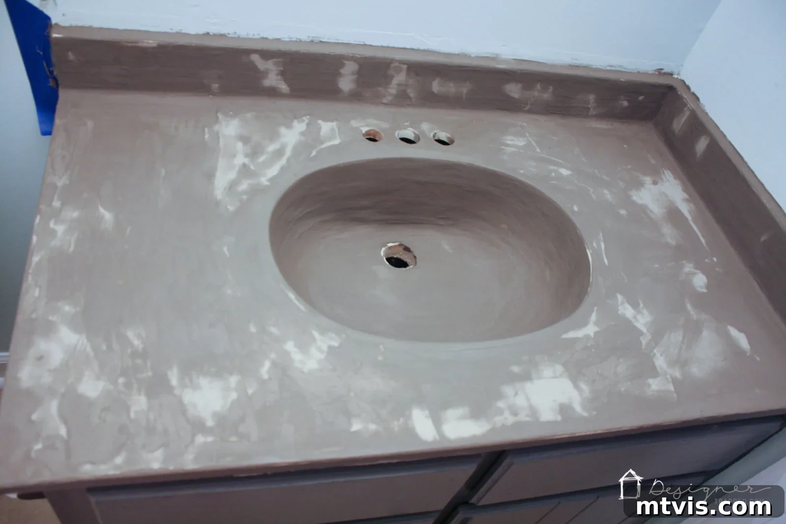 Effortless DIY Concrete Vanity and Sink No Forms No Heavy Lifting 9 A wide shot of a bathroom vanity with the second coat of concrete overlay drying, showing its temporary uneven and splotchy appearance.