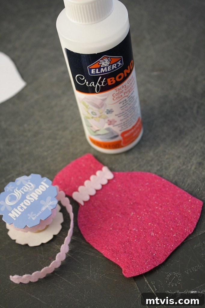 Felt Doll Magic: Create Your Own Playtime Friends 5 Hands carefully gluing small embellishments onto felt doll clothes, demonstrating the detailed and creative process of customizing outfits.