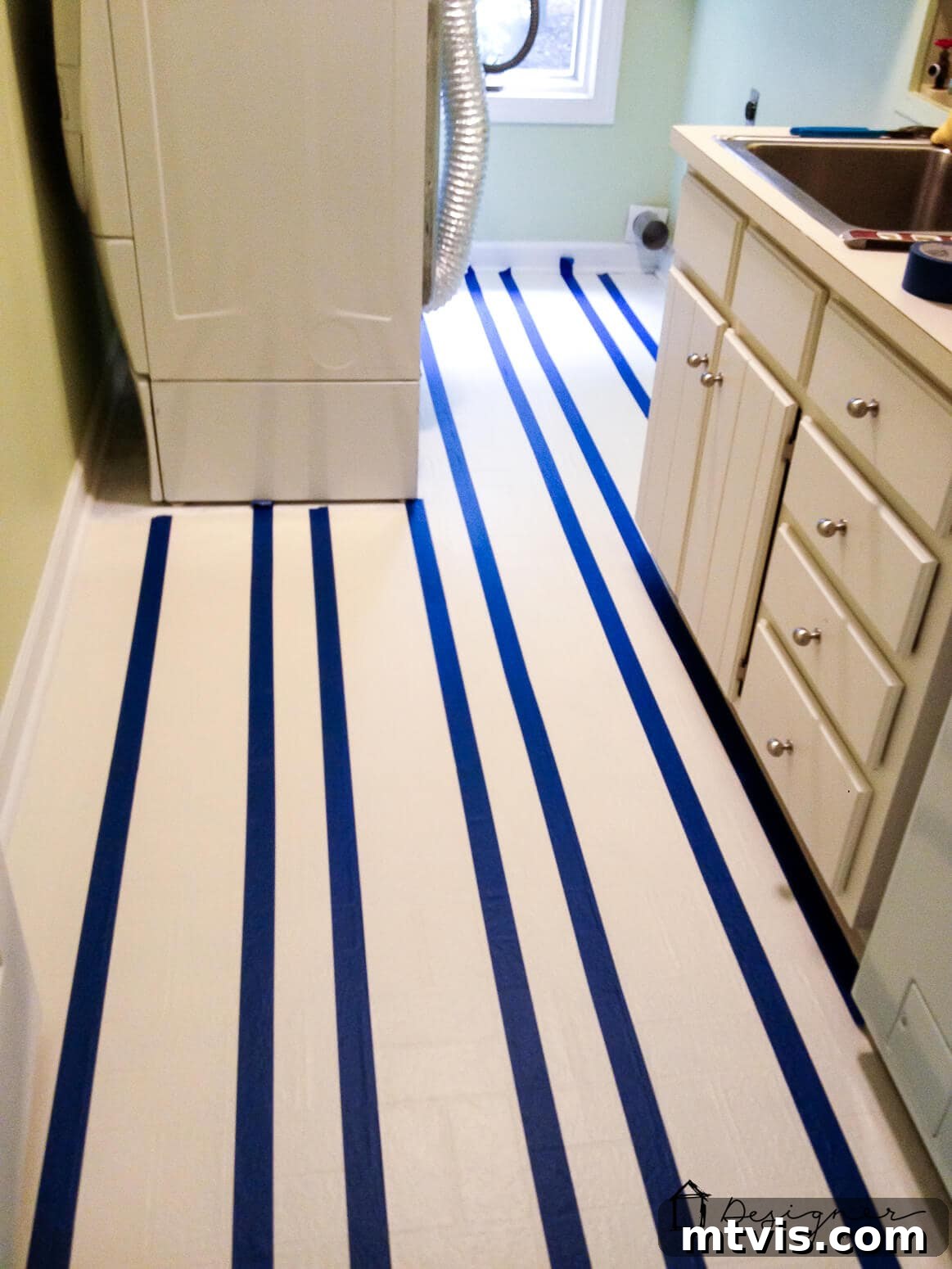 Mastering Durable Vinyl Floor Painting 6 Taping off vinyl floors to create a striped pattern before painting