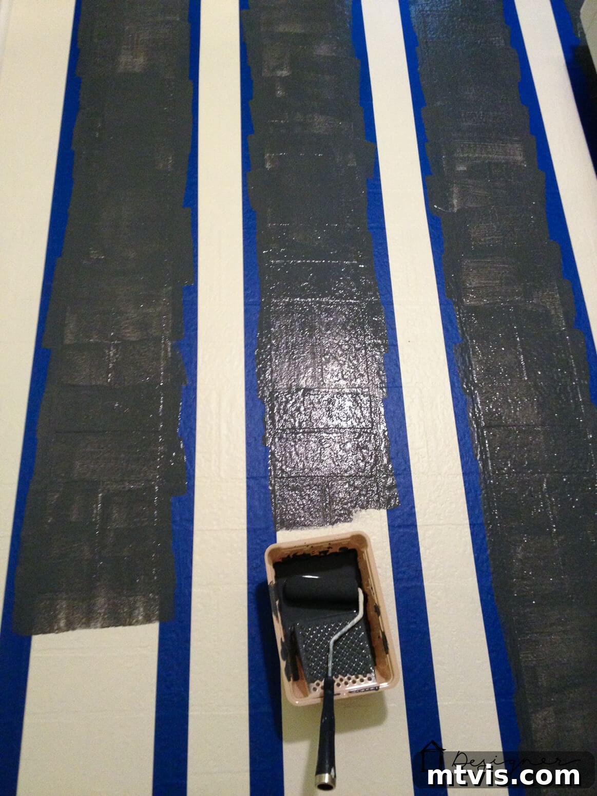Painting charcoal grey stripes onto a primed and base-coated vinyl floor