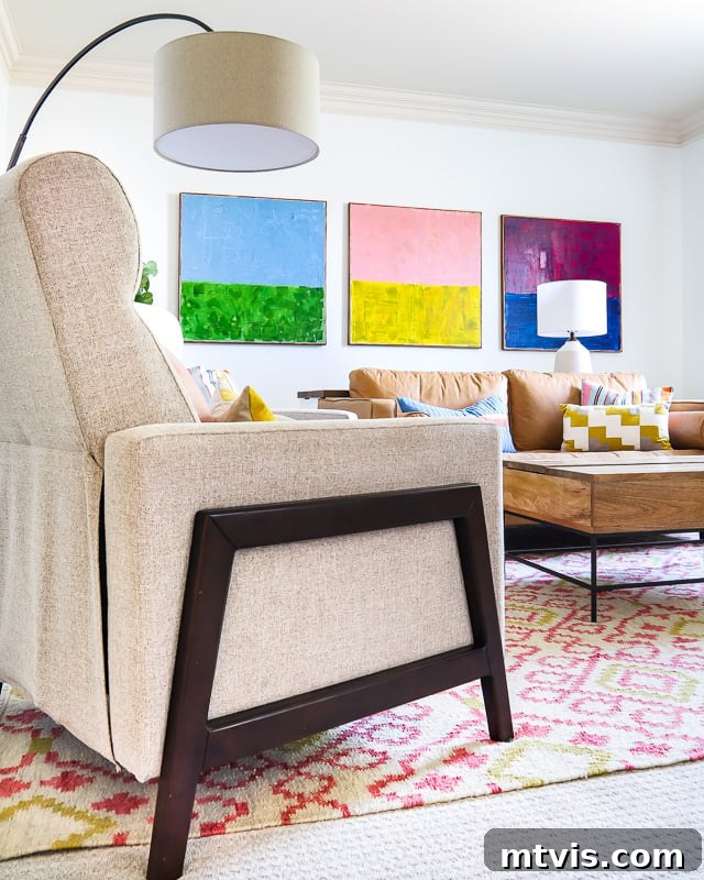 Our Family's Colorful Oasis: A Bonus Room Tour 11 Colorful DIY painted canvases displayed on the back wall of the bonus room, adding artistic flair
