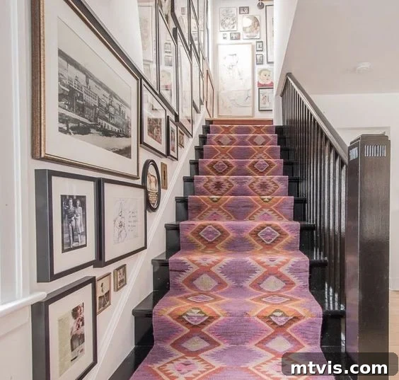 Elevate Your Entryway: Creative Stair Runner Designs 11 An Annie Selke pink stair runner with a geometric diamond pattern beautifully complements black stairs, creating a focal point alongside a stylish gallery wall.