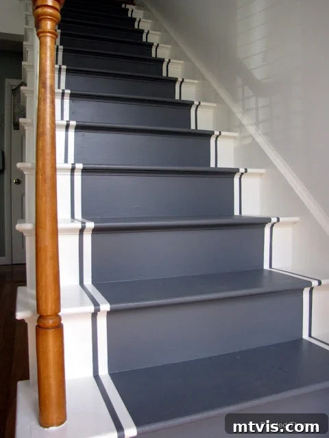 Elevate Your Entryway: Creative Stair Runner Designs 12 A DIY white and dark grey painted runner on stairs, offering a chic and tailored design solution. The subtle corner text reads, 'Painted Therapy'.