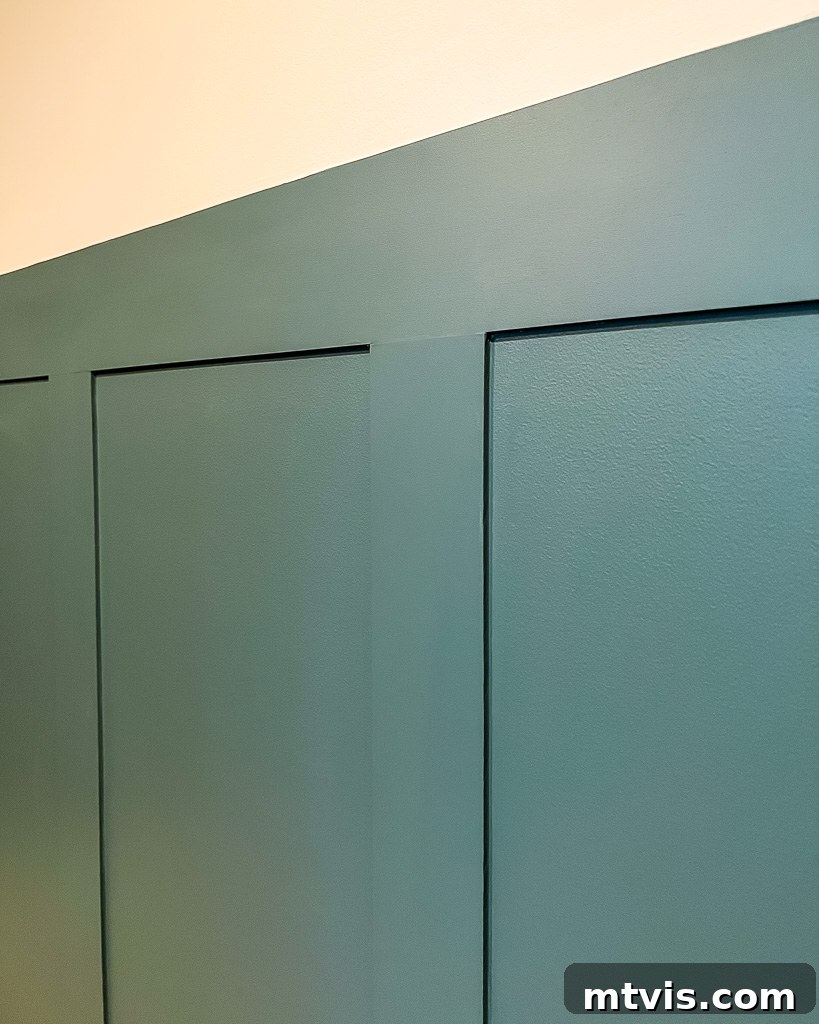 Effortless Board and Batten Accent Wall DIY 12 Detail of a finished board and batten accent wall showing smooth caulk lines and paint