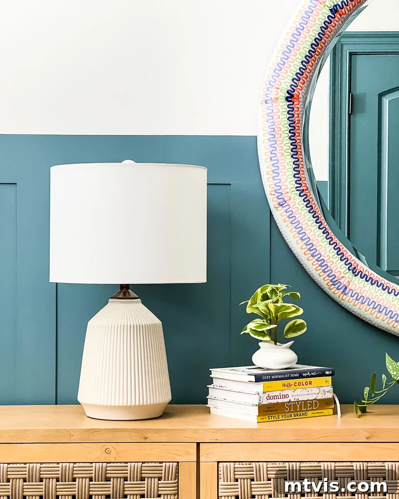 Effortless Board and Batten Accent Wall DIY 15 Stylish decor on a board and batten accent wall, featuring a mirror and lamp