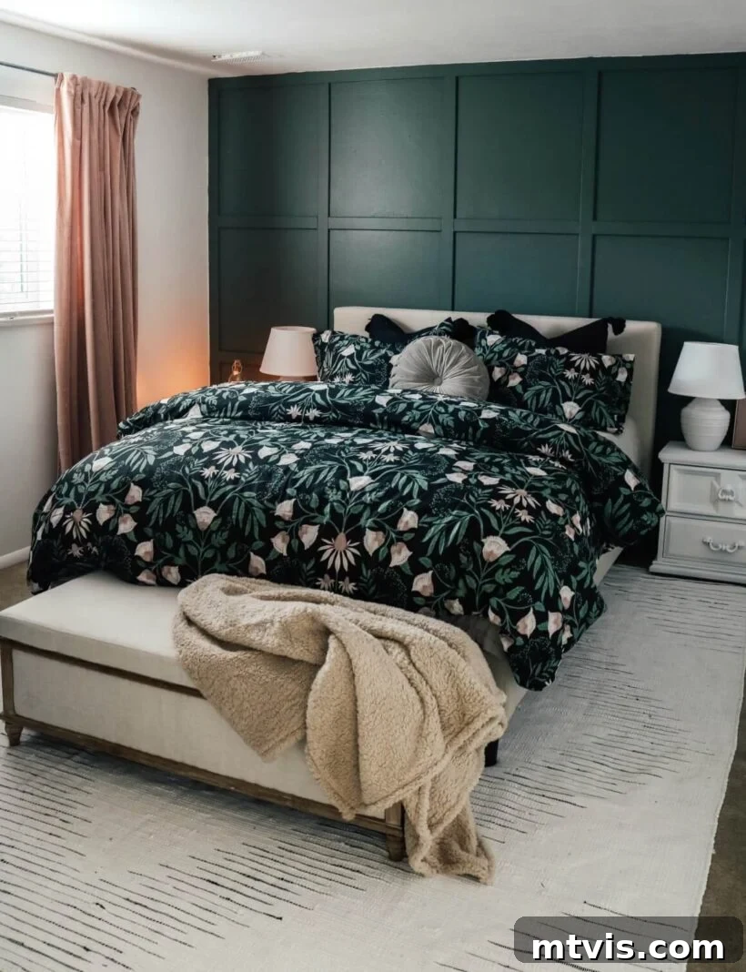 A dark green bedspread stands out against white accents and a deep green board and batten grid pattern on the accent wall. 
