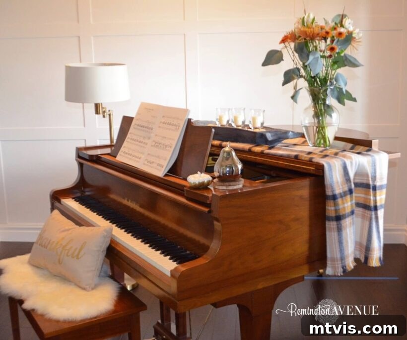 A beautiful oak grand piano is in front of a white board and batten grid wall. 