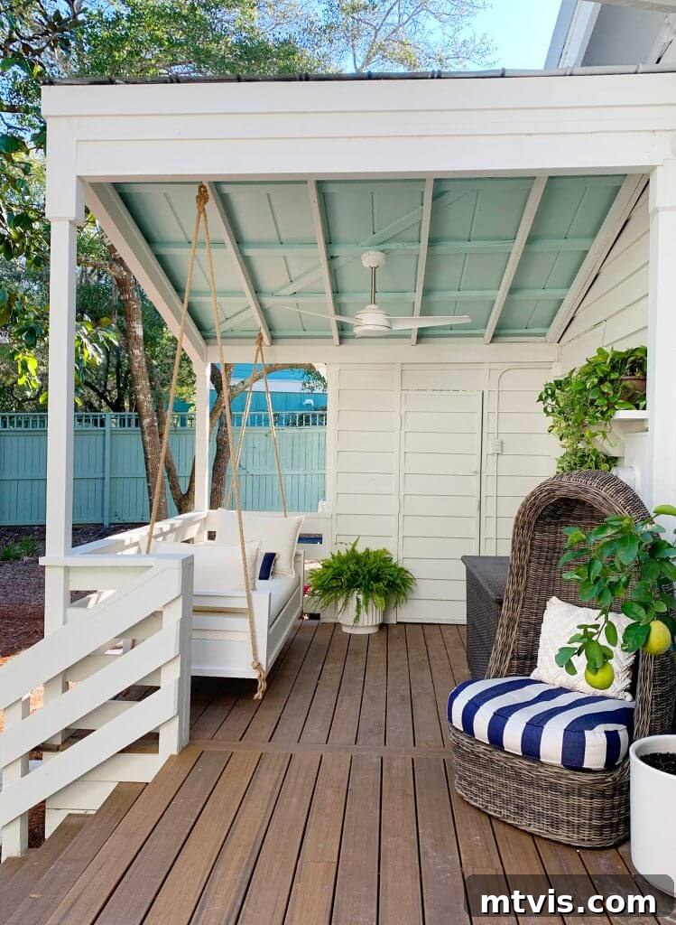 Unlock Your Porch's Potential: Designer Decor Secrets 11 DIY hanging daybed on a back porch, adorned with soft cushions and pillows