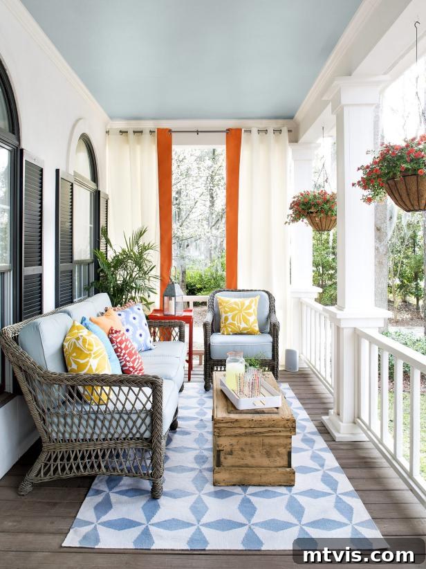 Unlock Your Porch's Potential: Designer Decor Secrets 14 colorful porch with blue and orange accents, patterned pillows, and striped curtains