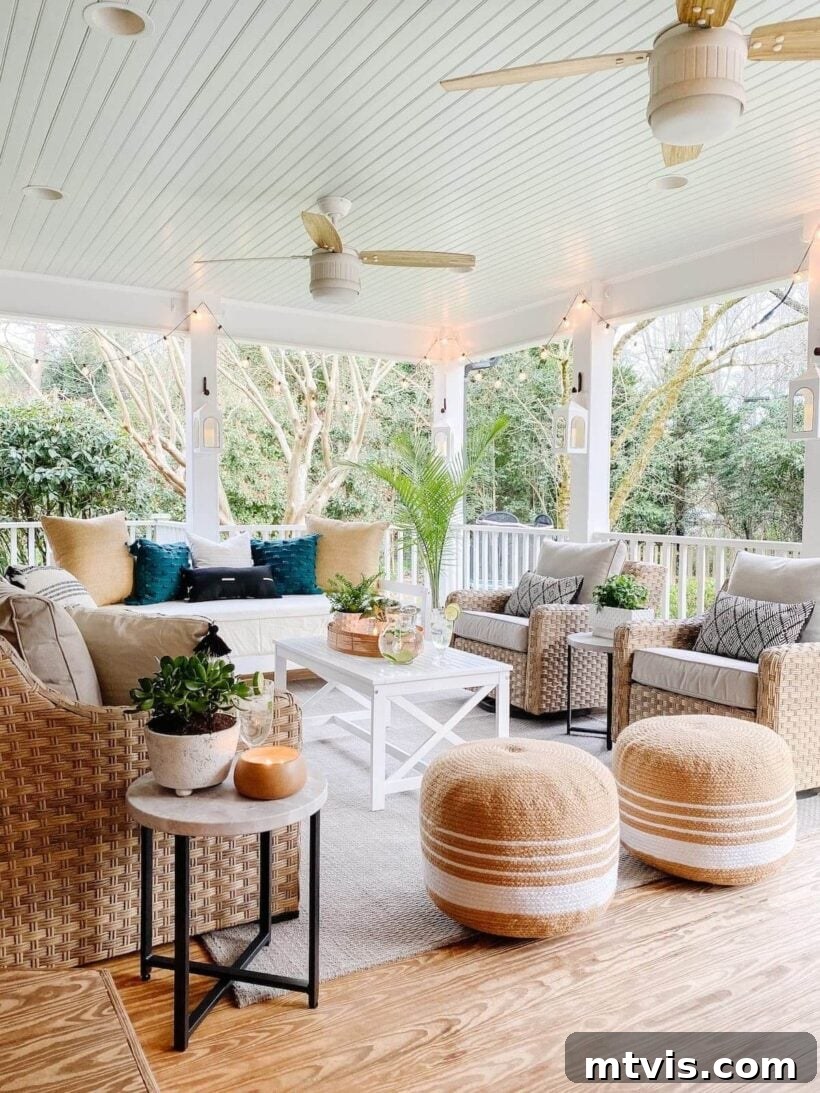 Unlock Your Porch's Potential: Designer Decor Secrets 17 large conversation area on a back porch, featuring ample seating and poufs around a central coffee table