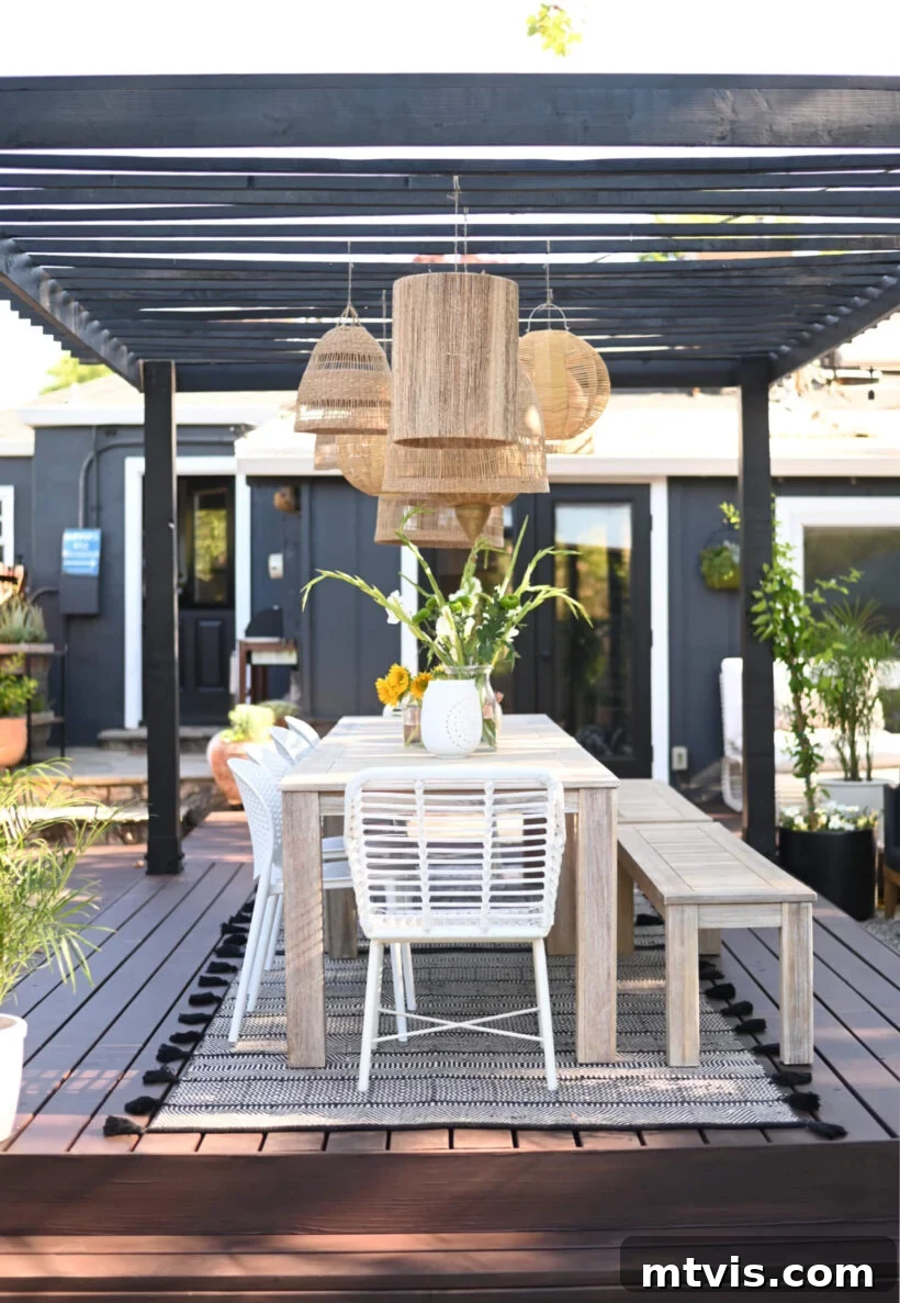Unlock Your Porch's Potential: Designer Decor Secrets 10 backyard patio with a pergola featuring layered rattan pendant lights creating a stunning focal point