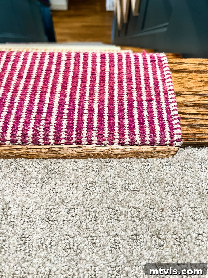 Ultimate Guide to Stair Runner Installation 18 Oak quarter-round molding installed as a transition piece between the stair runner and hallway carpet.