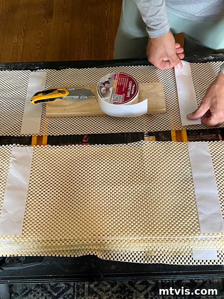 Ultimate Guide to Stair Runner Installation 7 Applying double-sided carpet tape to a cut rug pad before attaching to the stair tread.