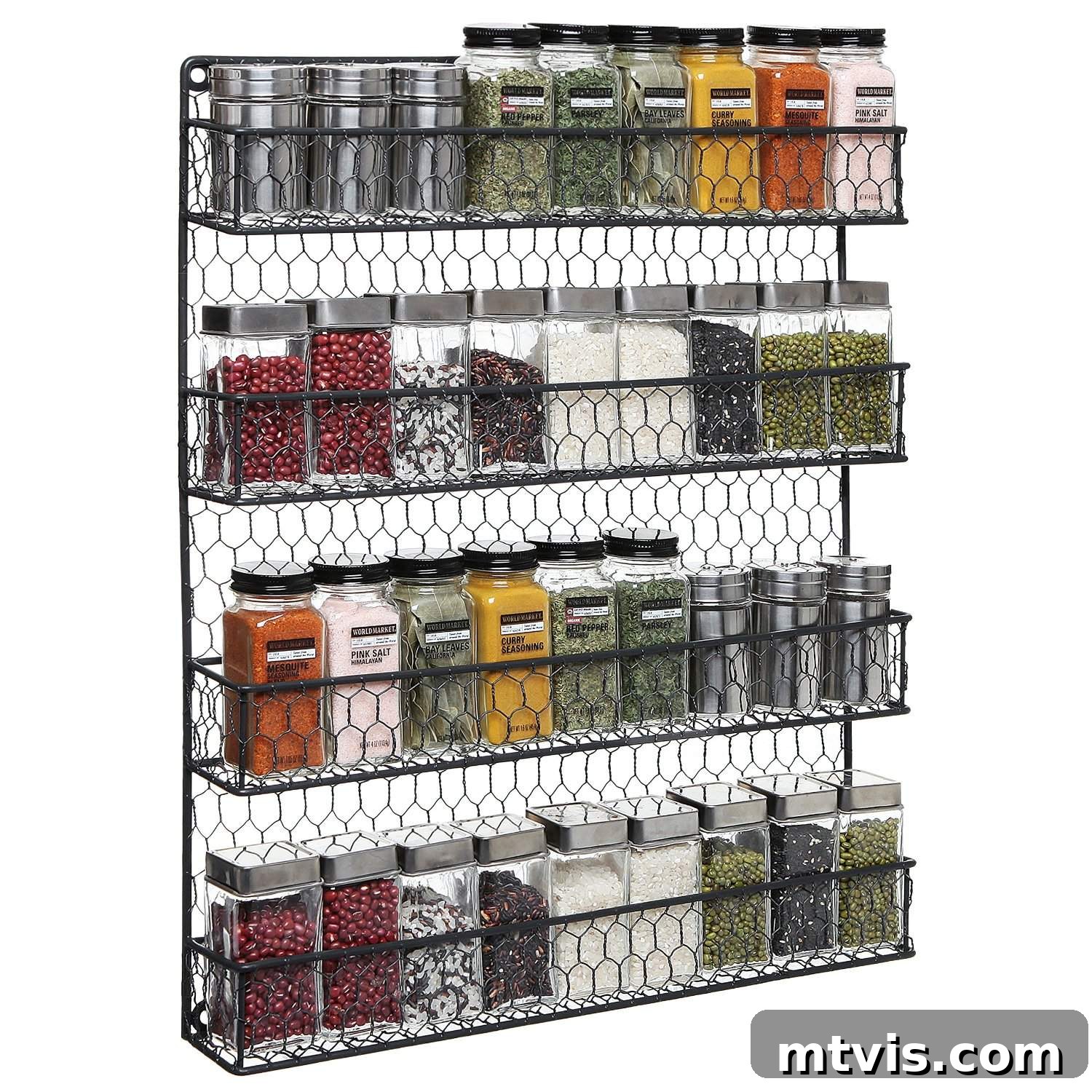 Everyday Kitchen Cabinet Organization 19 A chicken wire hanging spice rack full of varying spices, both ground and unground against a white background.