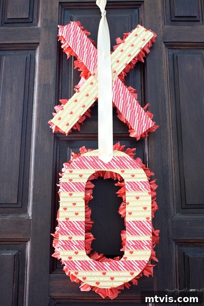 Valentines Door Decor DIY 14 The finished fluffy tissue paper 'O' letter, with a gold satin ribbon loop attached for hanging.