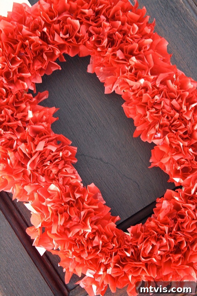 Valentines Door Decor DIY 17 A wider shot of the 'XOXO' tissue paper wreath, highlighting its charming, handmade appeal.