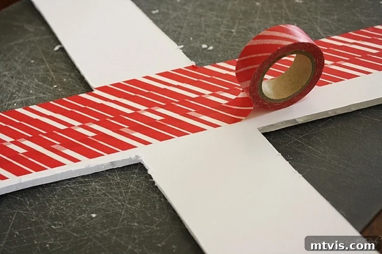 Valentines Door Decor DIY 6 Back side of a foam core letter being covered with decorative washi tape.