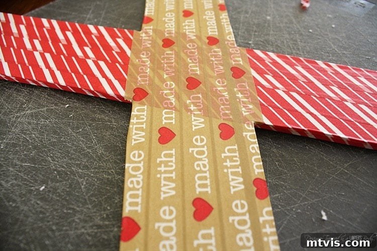 Valentines Door Decor DIY 7 Washi tape carefully wrapped around the edge of a foam core 'X' letter.