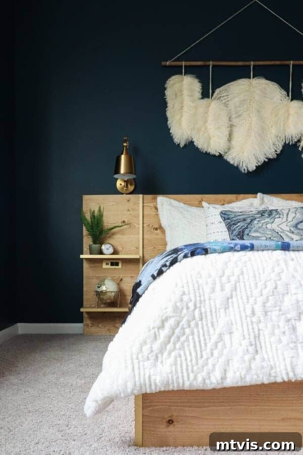 Luxurious moody navy walls in Sherwin-Williams Moscow Midnight paired with a natural wood platform bed.