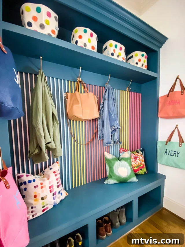 Mudroom built-ins painted in Fusion Mineral Paint's Seaside, providing a beautiful backdrop to a colorful DIY wood slat wall.