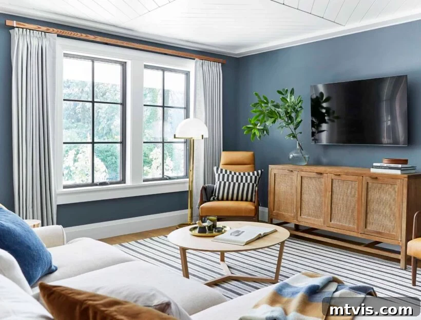 Serene blue-gray walls in Sherwin-Williams Waterloo create a crisp atmosphere in a family room.