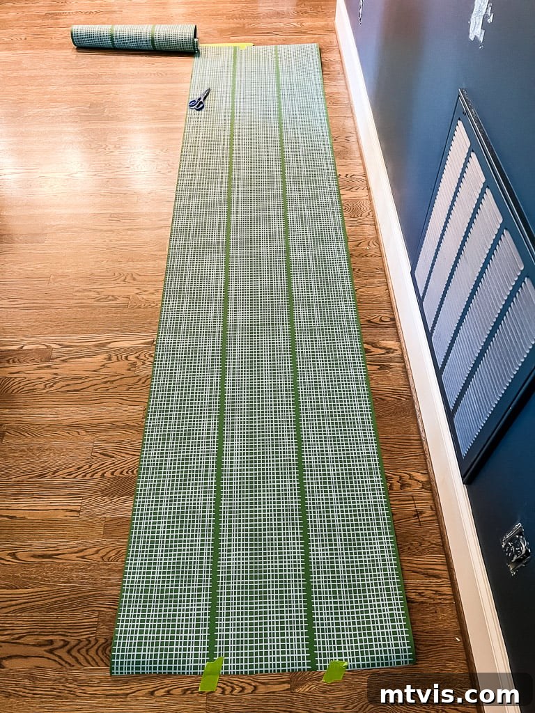 Measuring and cutting wallpaper strips, ensuring excess for trimming