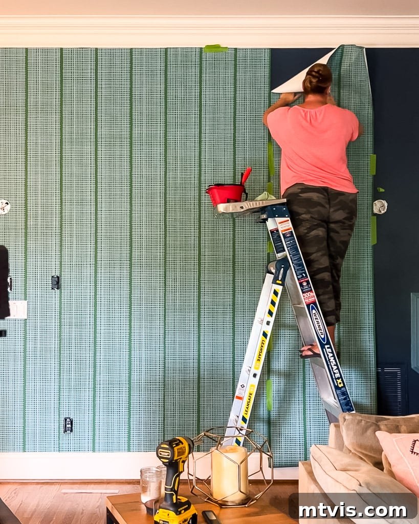 Renter-Friendly Wallpaper: Simple Steps for Easy Removal 8 Smoothing down wallpaper panel with a damp rag after applying liquid starch