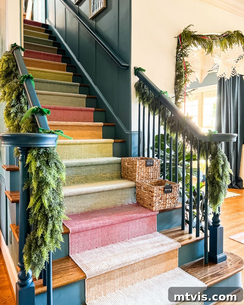 Vibrant, realistic faux garlands beautifully adorning a colorful staircase, creating a festive and inviting atmosphere for Christmas.