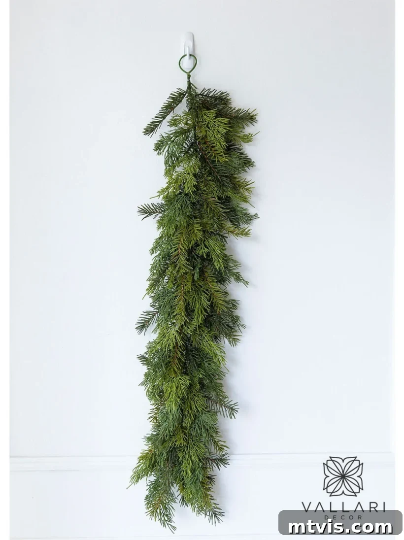 A realistic faux real touch cedar and hemlock garland, showcasing its natural texture and color variation, perfect for elegant holiday decor.
