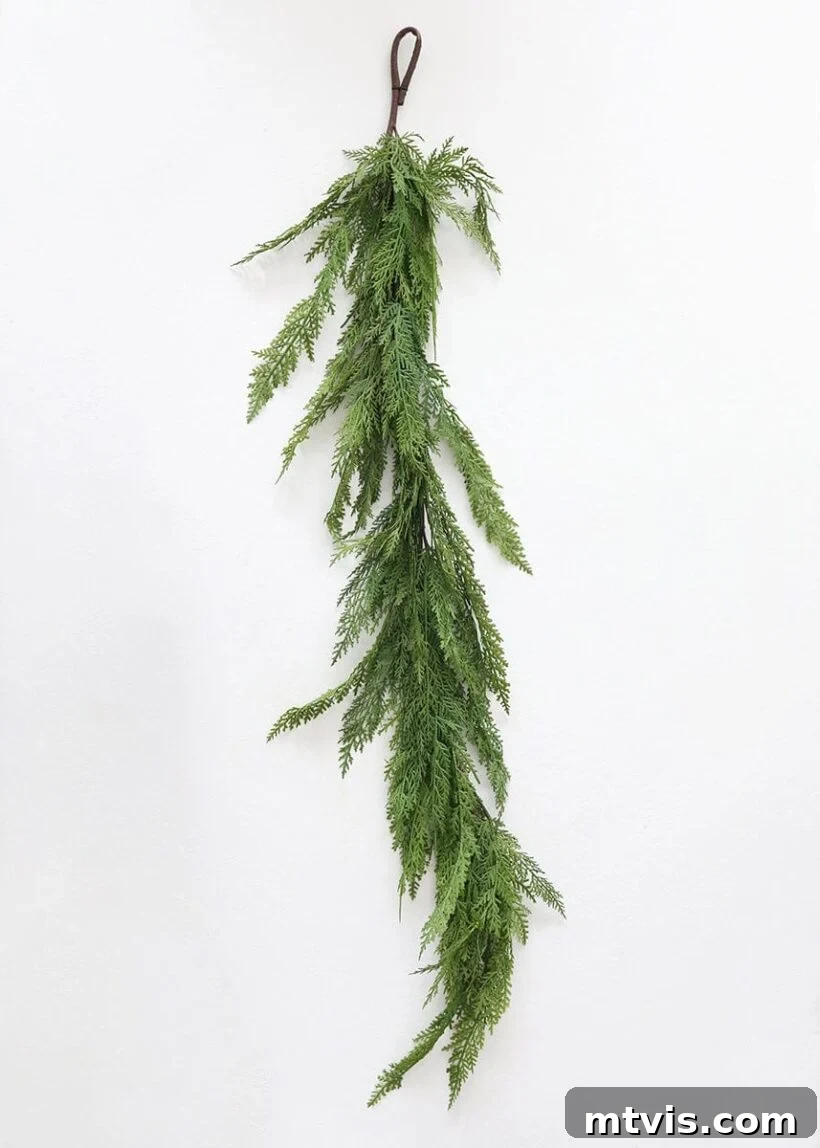 Afloral real touch cedar holiday greens garland, displaying its lush, natural appearance and vibrant green hues.